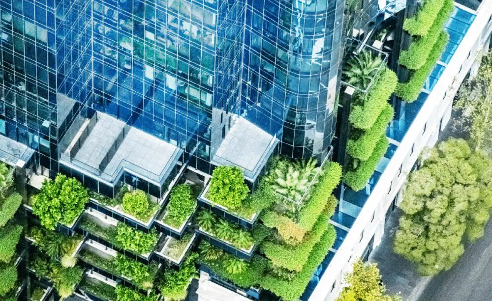 Modern skyscraper with green rooftop terraces.